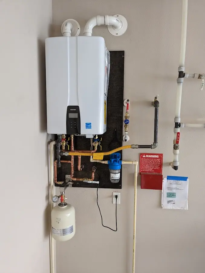 Professional plumber installing copper piping in a Pensacola home